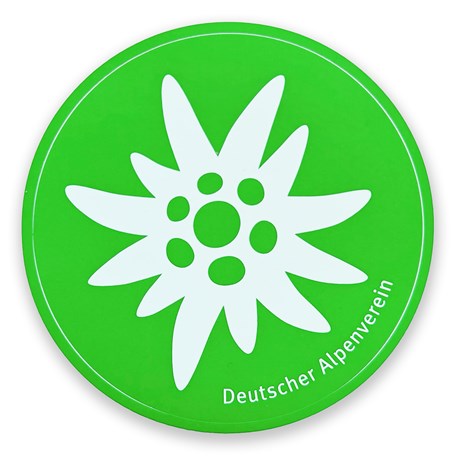 runder Aufkleber mit weißem Edelweiß und grünem Hintergrund